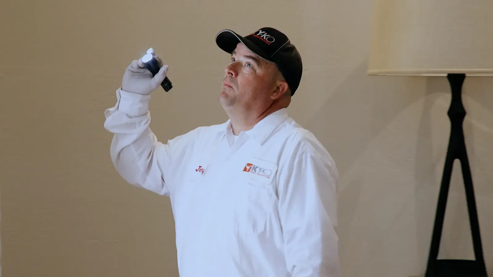 KY-KO technician inspecting with a flashlight